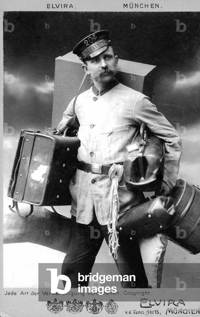 Porter with suitcases, 1910 (b/w photo)