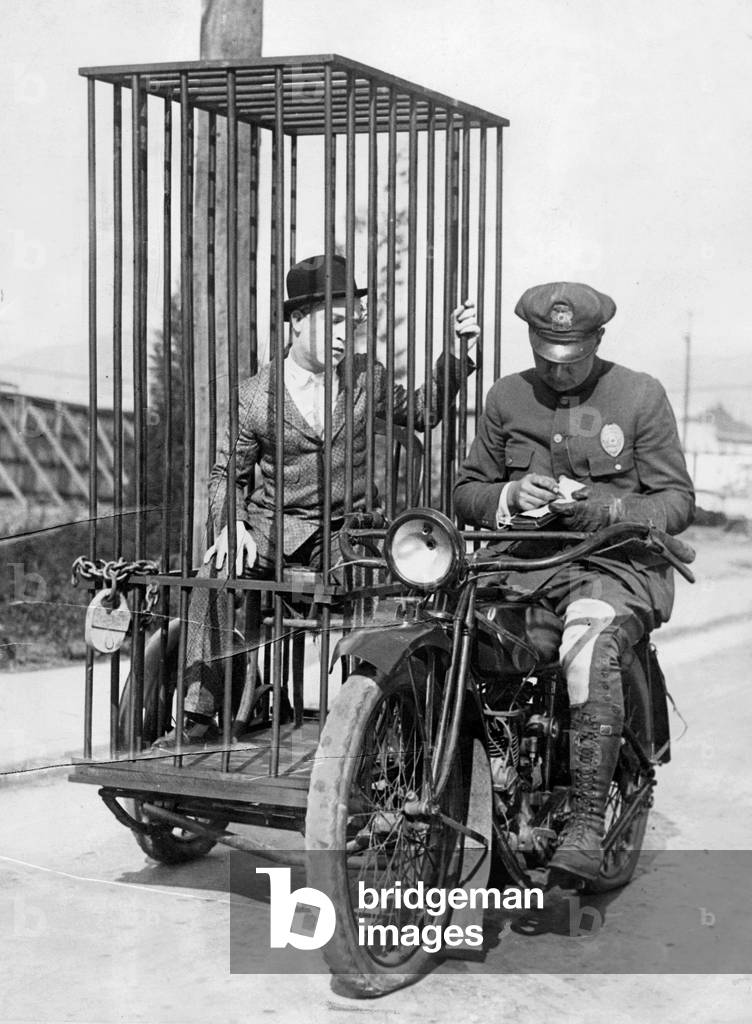 Policeman on a motorcycle for the prisoner transport (b/w photo)