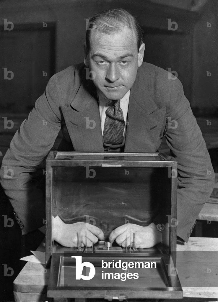 Man demonstrates the filling of radium, 1932 (b/w photo)