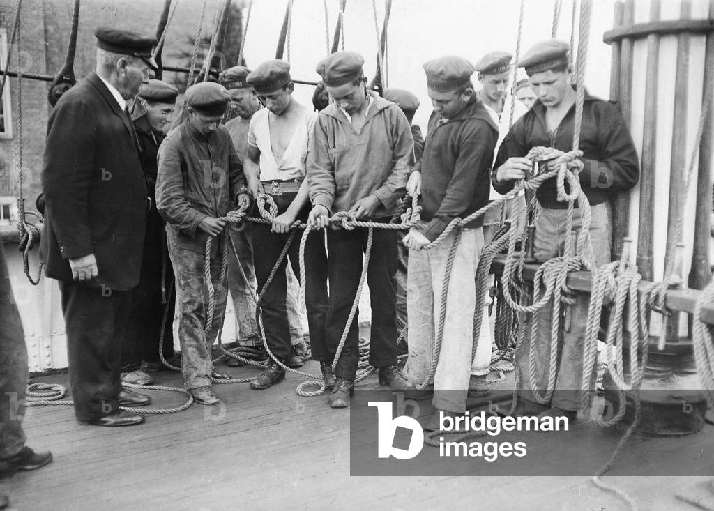 Sailors learn to tie knots, around 1925 (b/w photo)
