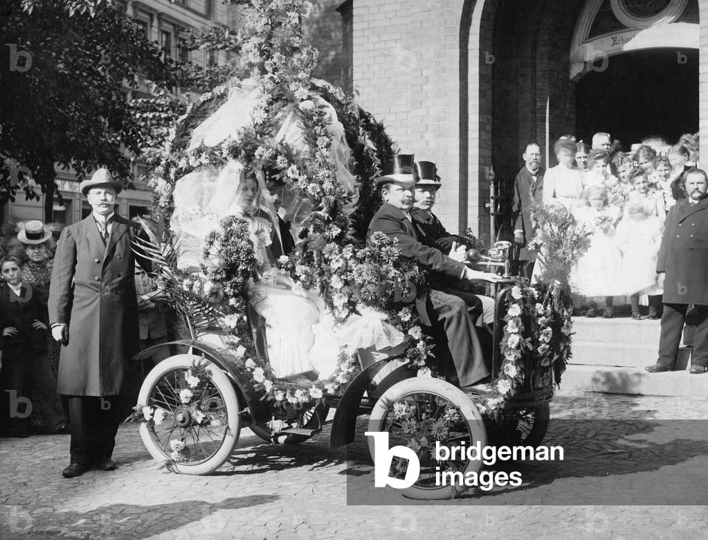 Wedding couple on motorcars, c.1900 (b/w photo)