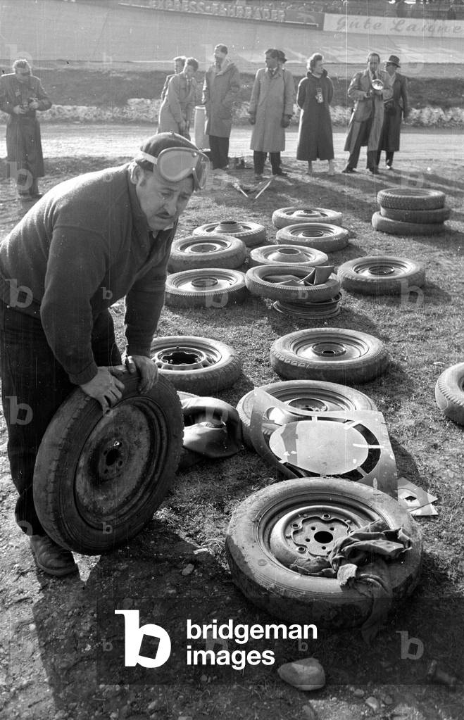 Spare tires for the vehicles of a stock car race, 1954 (b/w photo)