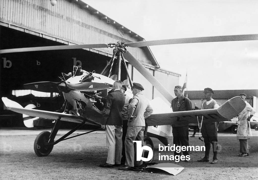 Autogyro at an airfield (b/w photo)