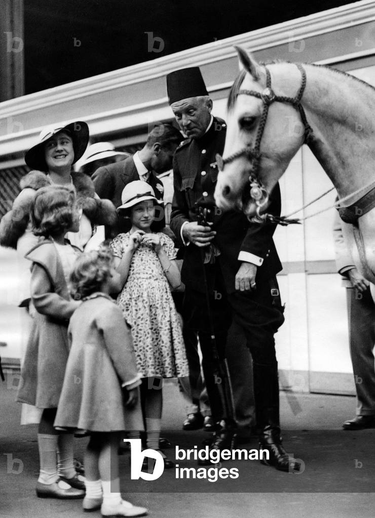 Elizabeth, Duchess of York, Princess Margaret Rose, Princess Elizabeth and George VI, Duke of York, at the International Horse Show, 1934 (b/w photo)