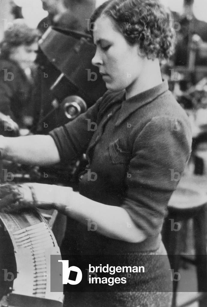 Female Polish worker in a munitions factory, 1940 (b/w photo)