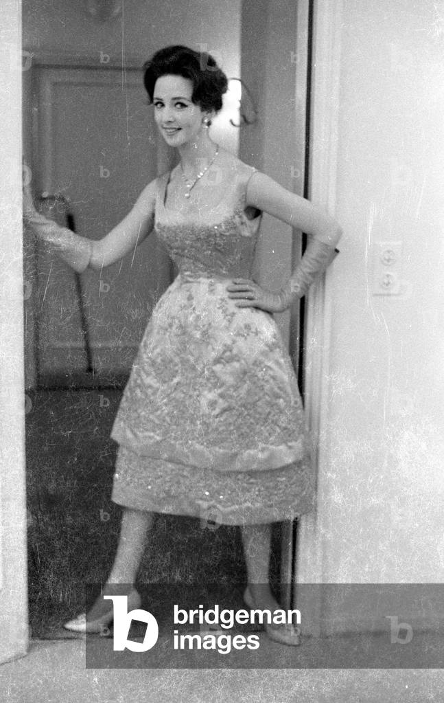 A model presents clothes from new collections, 1959 (b/w photo)