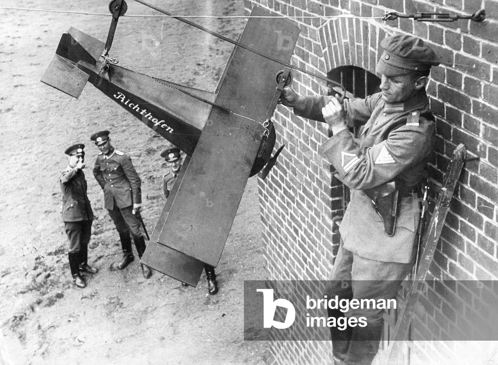 National Defense Soldiers with a model airplane, 1932 (b/w photo)