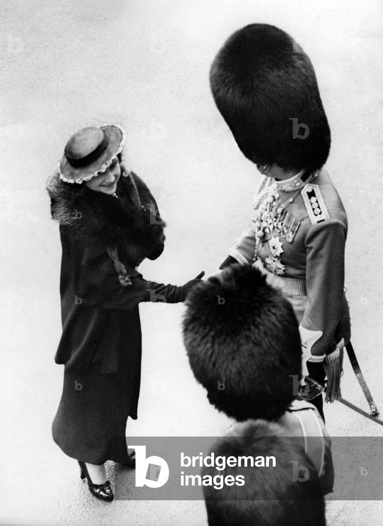 Queen Elizabeth welcomes an officer, 1937 (b/w photo)