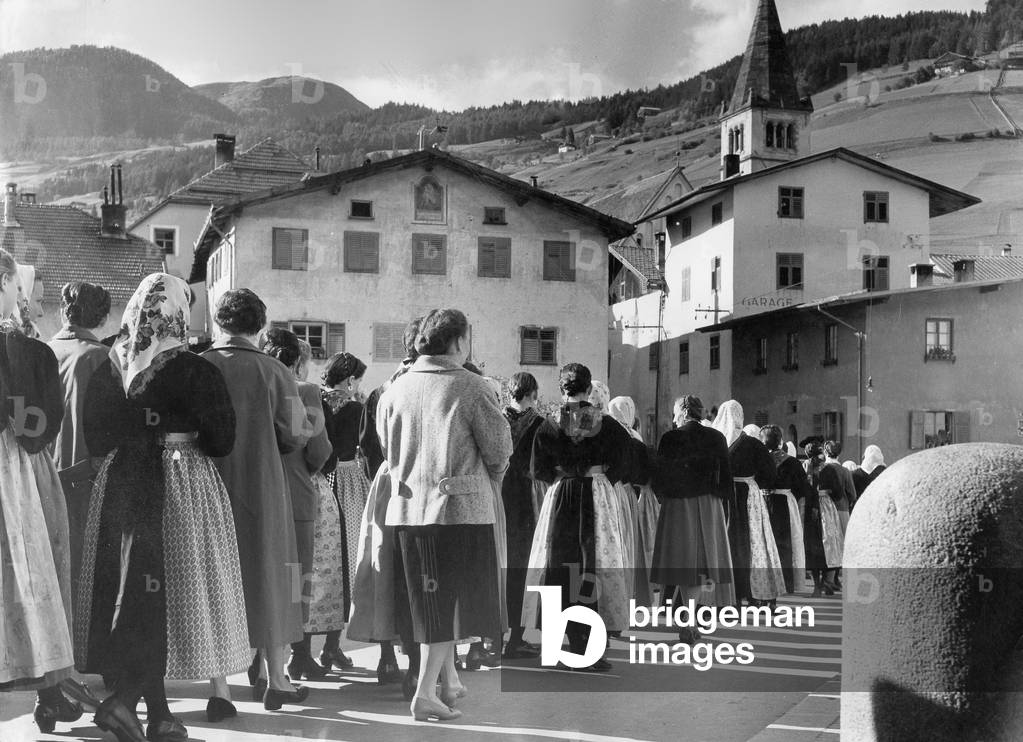 Going to church in South Tyrol, circa 1960 (b/w photo)