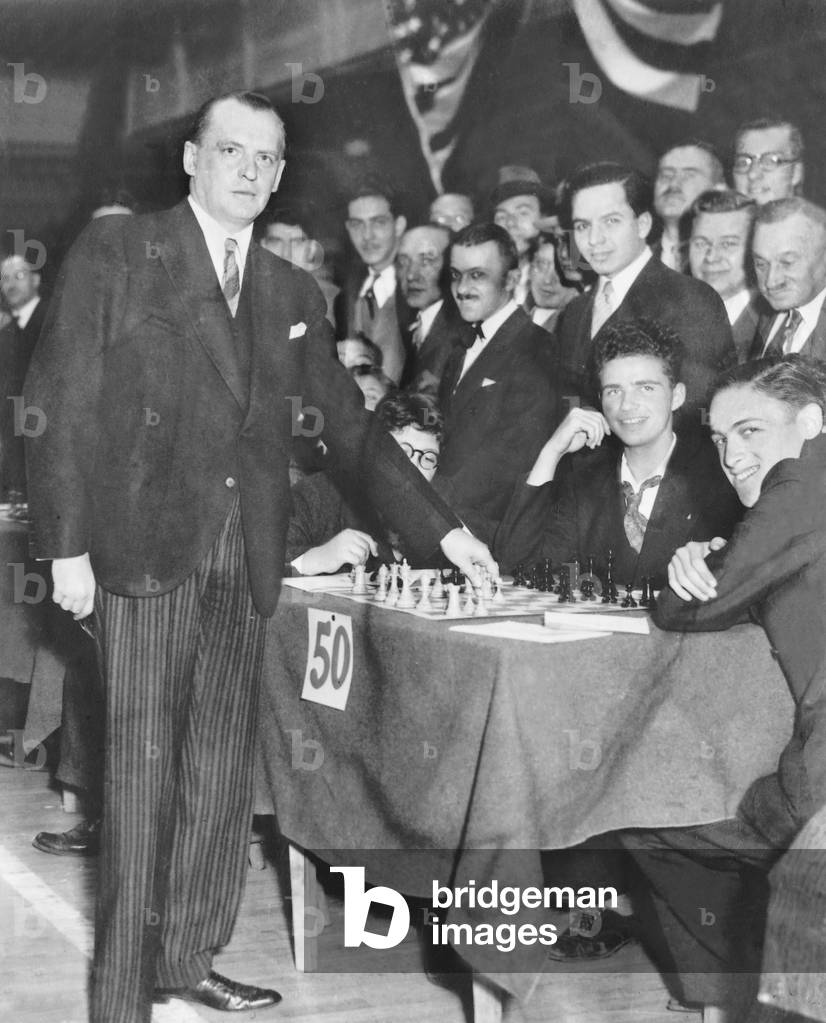 Alexander Alekhine playing simultaneous chess matches (b/w photo)