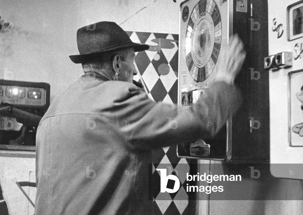 Man uses a gaming machine (b/w photo)
