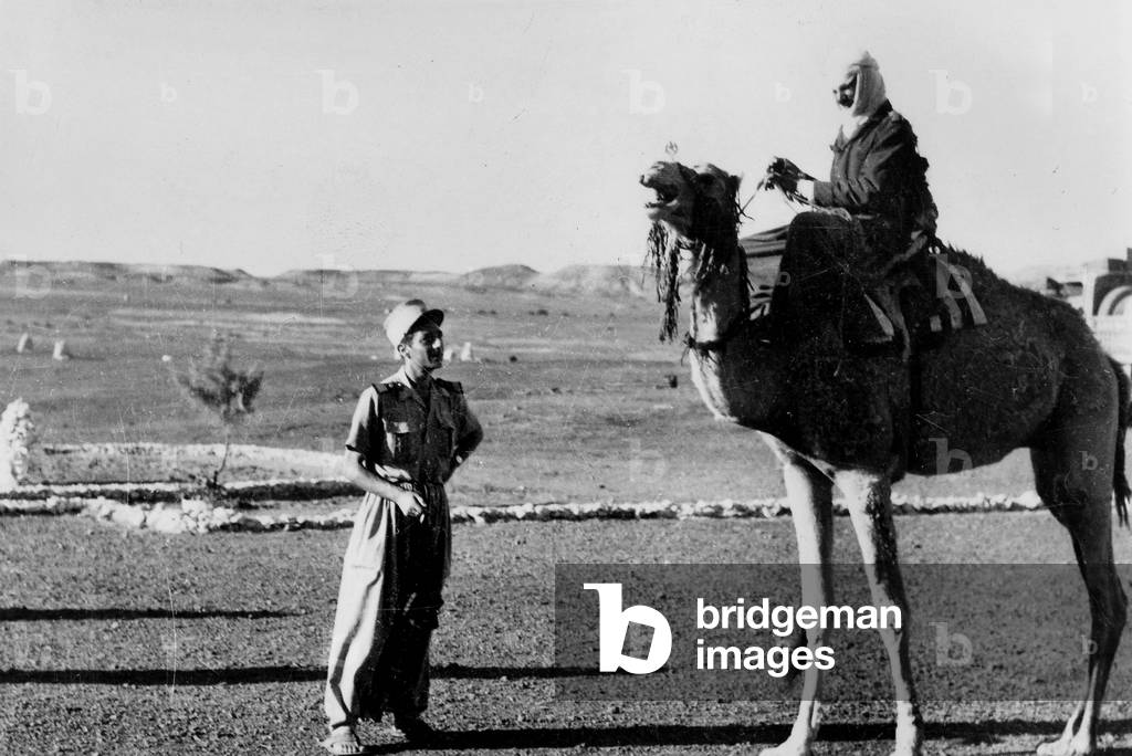 In Brack in Fezzan, Libya, soldier of the French Camel corps with one of his camel riders in desert, 1947