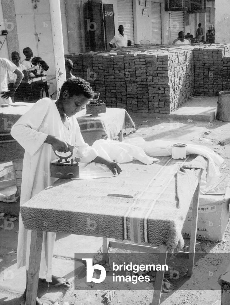 child working as presser in Khartoum, Sudan