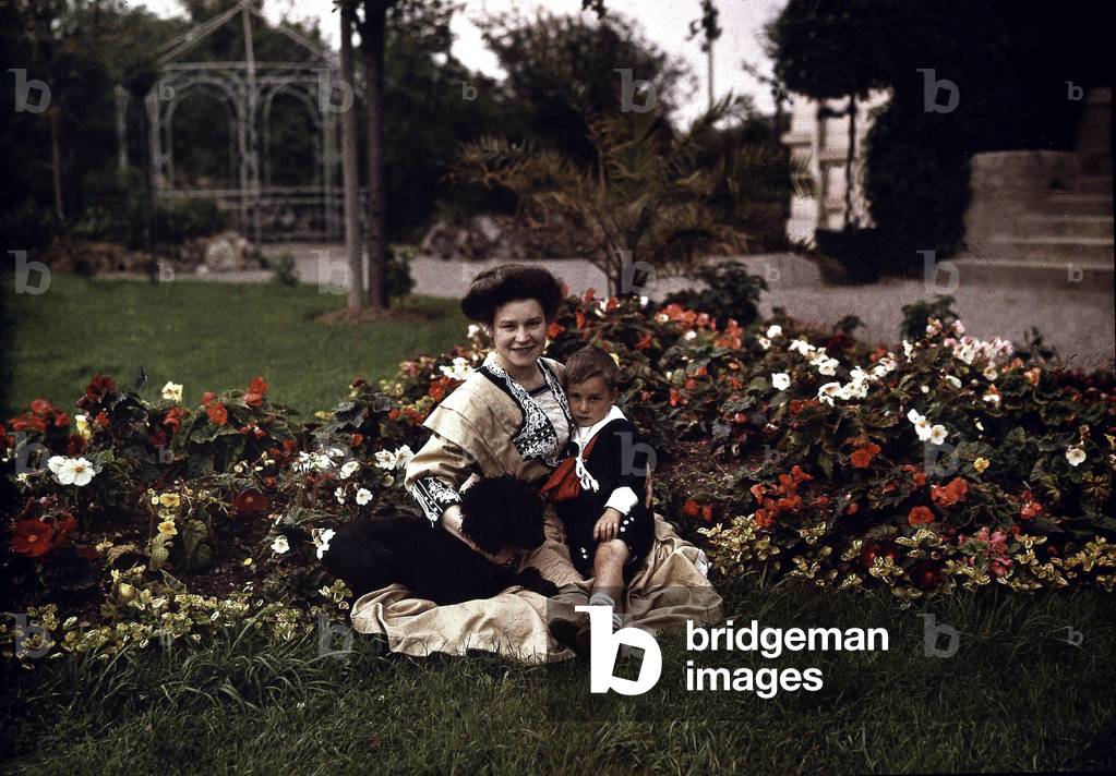 Woman with her child and a dog in a garden, c. 1910, autochrome Lumiere (color photo on glass, 1st color photography process invented in1903)
