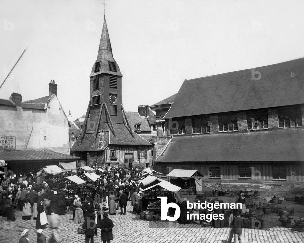 The market in Honfleur in Normandy (France) with Saint Catherine church built with wood, c. 1900