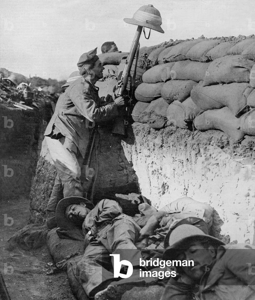 Irish soldier in allied trench taunting turkish soldier with an helmet on his riffle, 1915