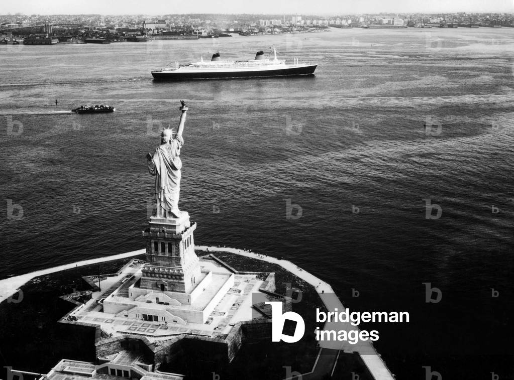 French liner France (used in 1962-1977) in New York in front of statue of Liberty