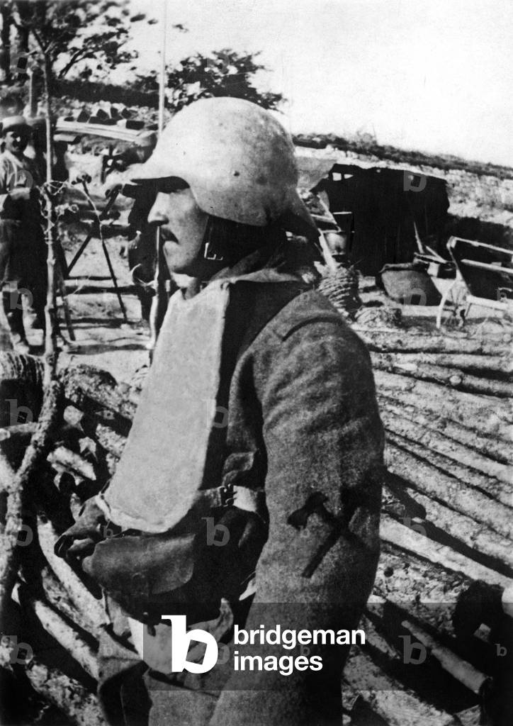 In Champagne (France) soldier with steel helmet, armour plating, 1916, photo by Branger