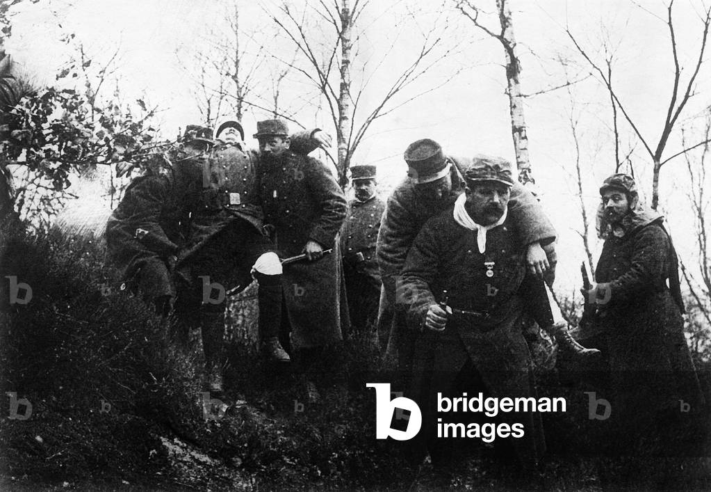 After fights in Argonne, France, French soldiers carrying wounded men, ww1