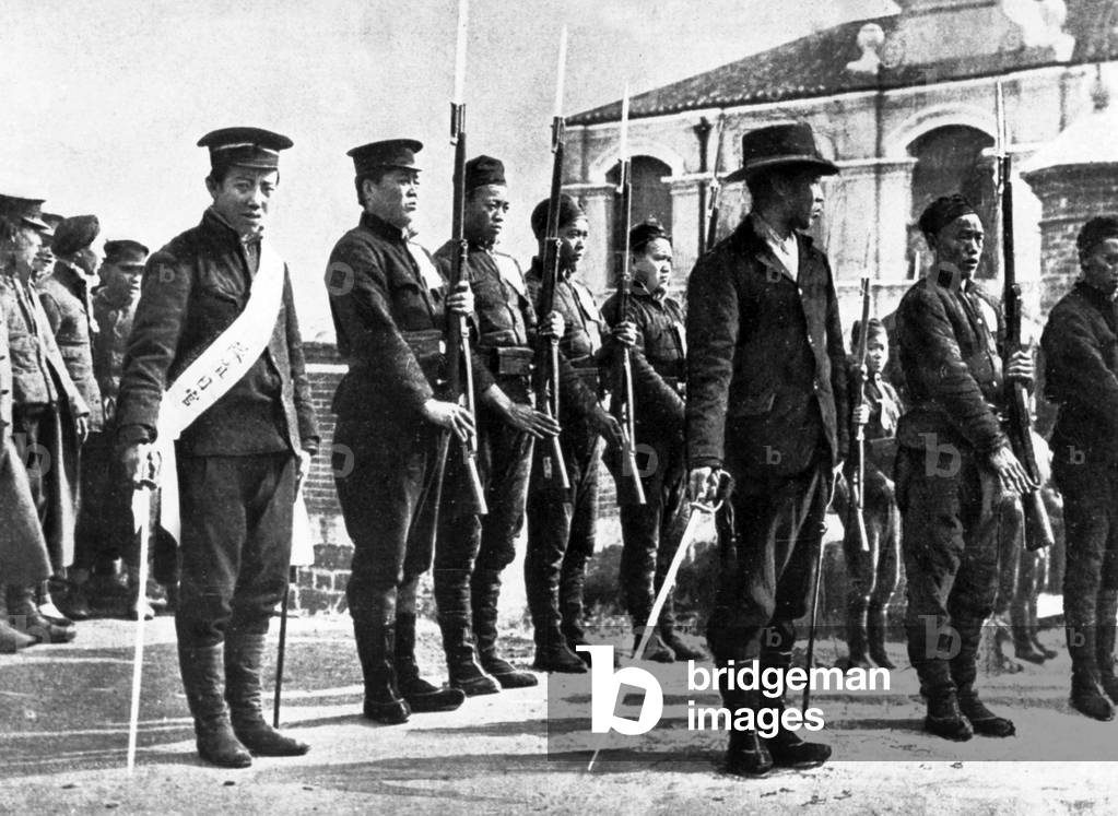 The revolutionary soldiers and their officers in different uniforms, stand to attention , in Hankeou, about 1922-1930