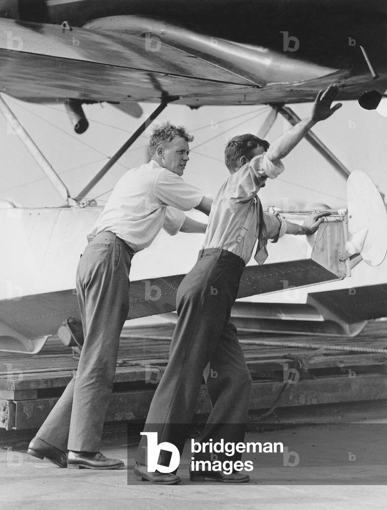 Charles A. Lindbergh  with plane with which he flew over Greenland july 1933