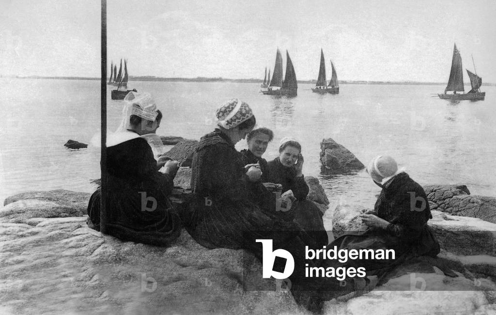 French women xaiting for boats (sardine boat) in Brittany, France, c. 1910