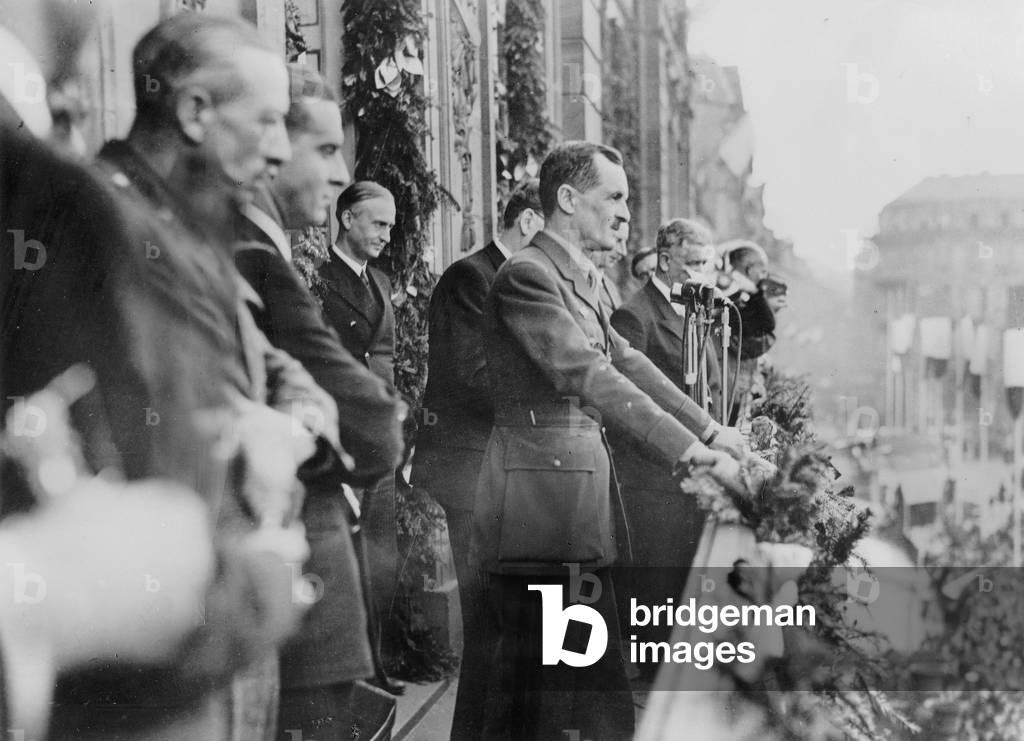 Alsace November 1945 : 1st commemoration of the Liberation of Strasbourg , the General Leclerc talks to the crowd from the cityhall's balcony on Place Broglie . Behind him on his left (profile) M. Pierre Pflimlin at the time young leader in M.R.P. who was mayor of the town from 1959 to 1983