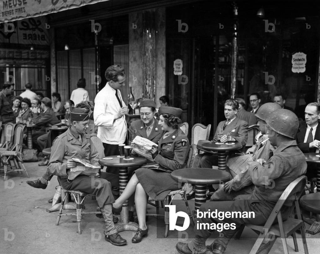 GI's and women of WAC (Women's Army Corps) reading the first continental edition of 