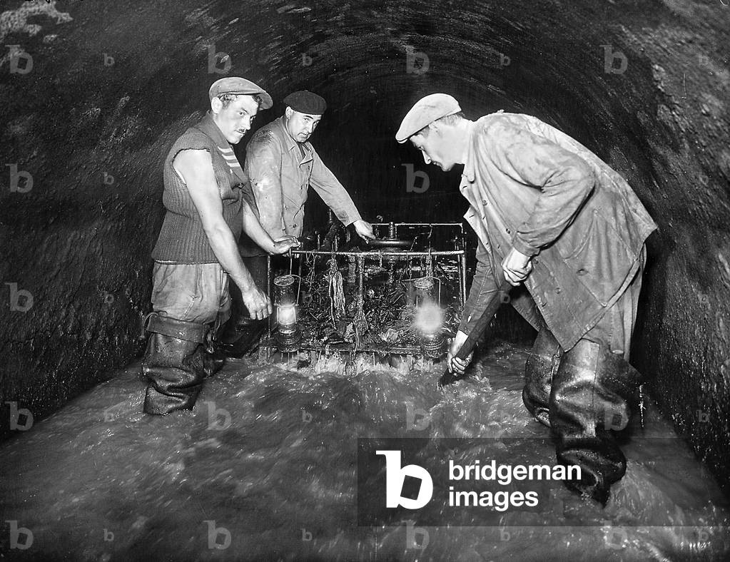 Miners opening gate in a mine gallery, North of France, 30's