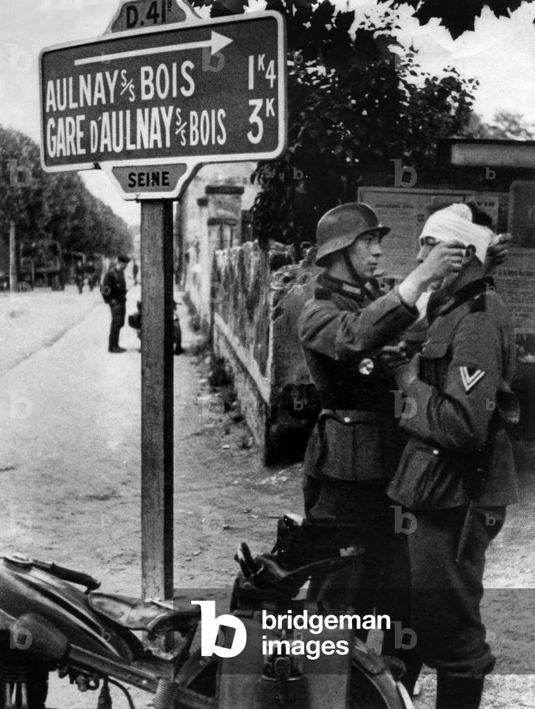 June 1940 : Germans are ready to go in Paris, here a wounded german soldier is treated by another soldier near Aulnay-sous-Bois