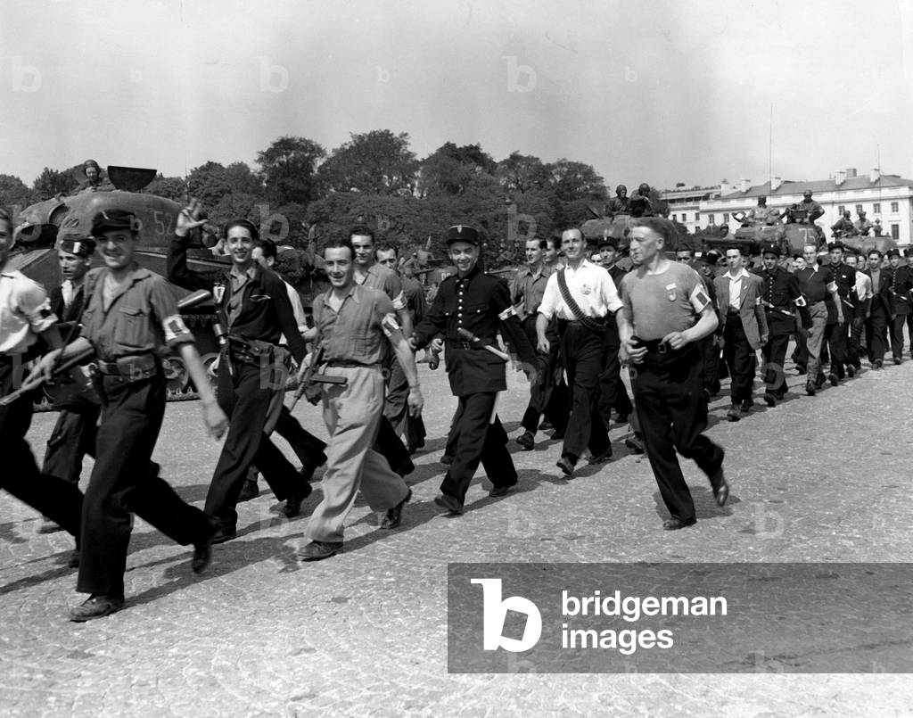 Members of the French resistance forces and gendarmes who held Paris until the arrival of allied military units marein down a Paris street celebrating the city s liberation They still carry the rifles and clubs with which they fought the Germans august 26, 1944 during the Liberation of Paris