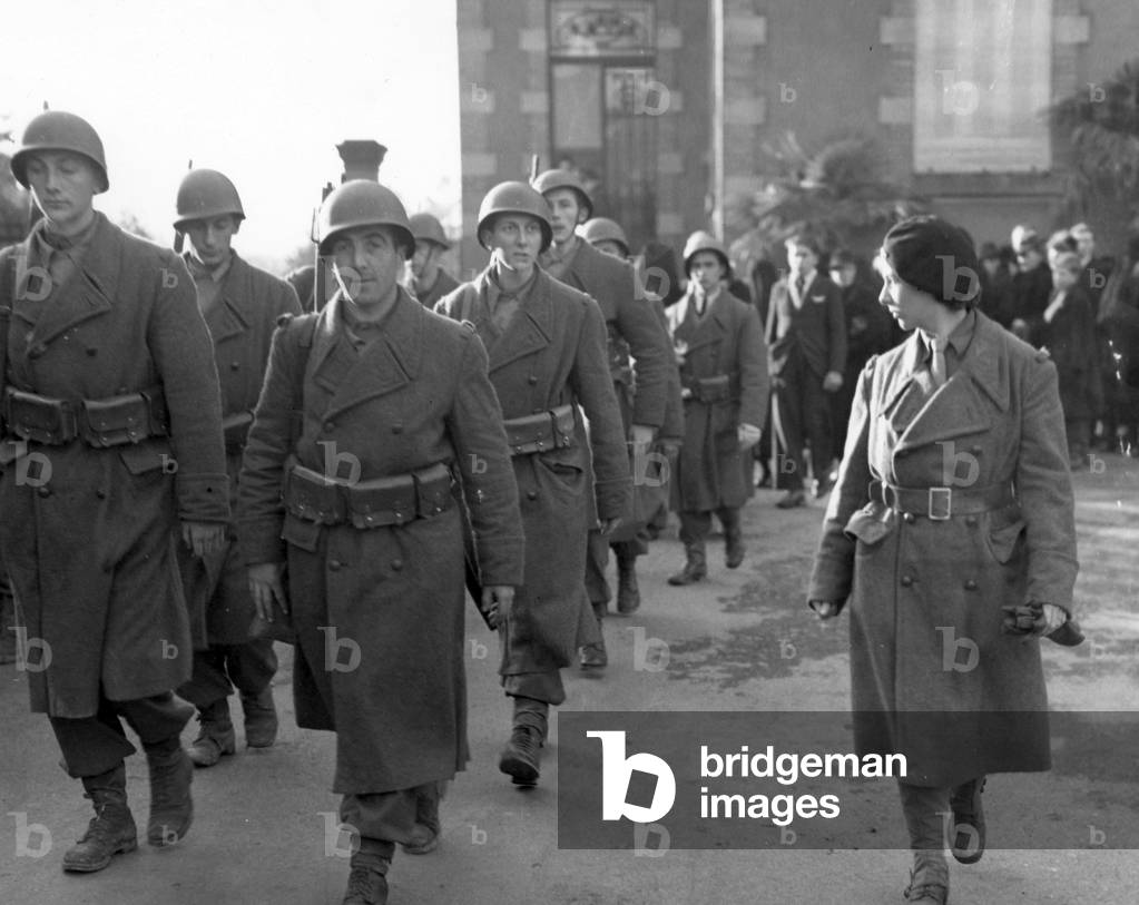 Sergent Jannette marches off with her maquis platoon honor guard after funeral services were held for civilians of Belfort in France who died in the siege of the city on november 27, 1944, photo NARA