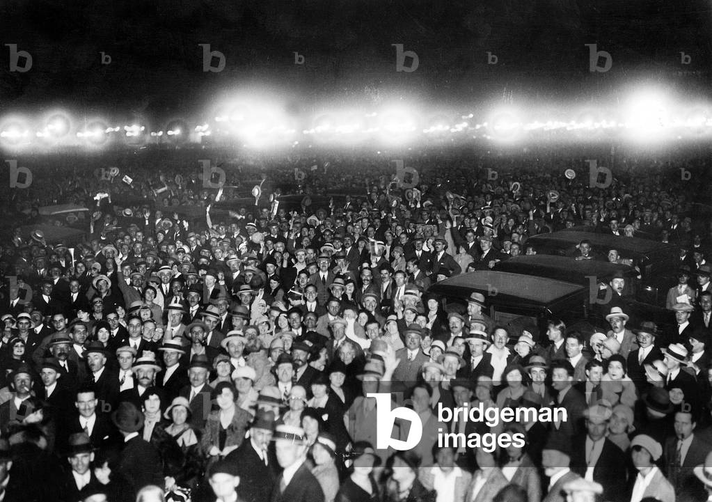 the night following the departure of Dieudonne Costes and Bellonte aboard plane Le Point d'Interrogation (Question mark) for the first non-stop flight from Paris to New York (37 hours flight) , the crowd in Paris waits for tha radio-announcing their arrival in New York september 1, 1930 aviation exploit feat