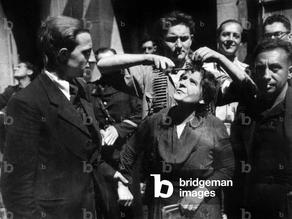 French woman accused to have collaborated with the germans during the war, just before being shaved in humiliation to show her treason, after the liberation in Laval, France august 1944