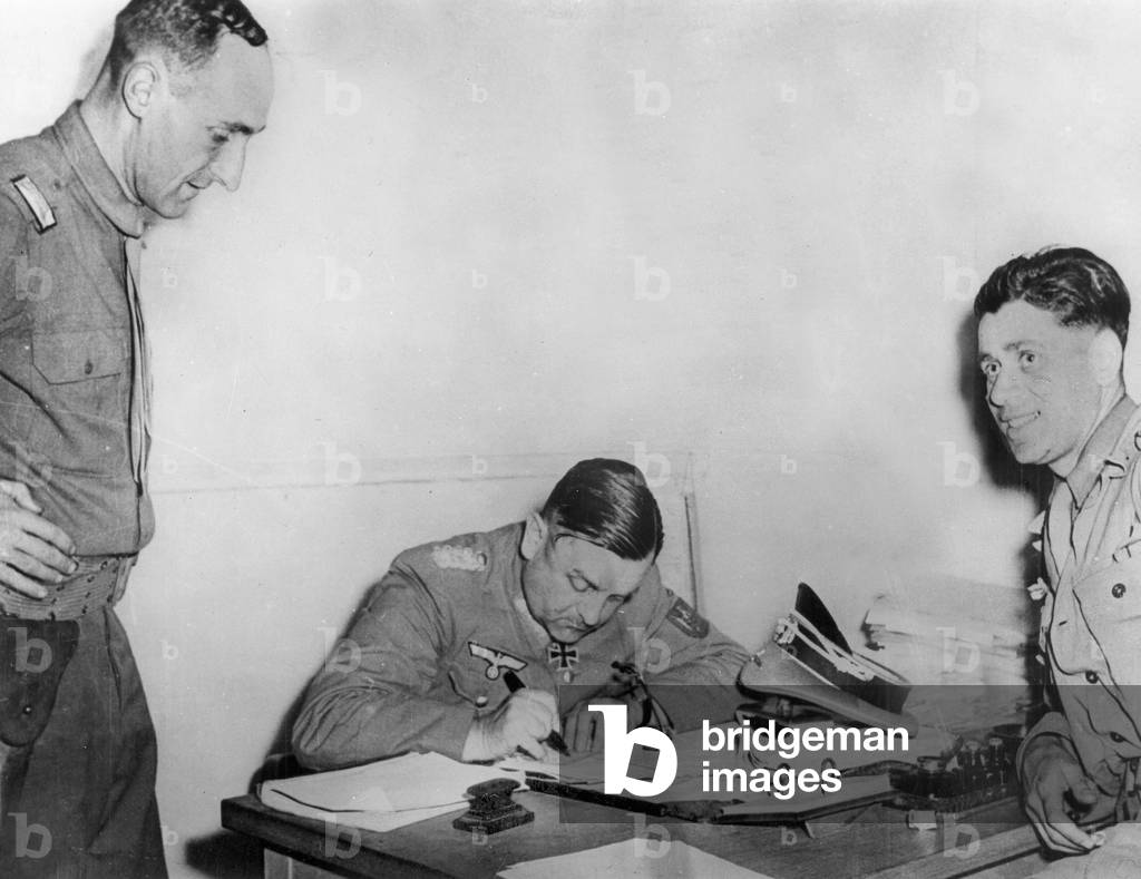 German redition, liberation of Paris : here german general Dietrich von Choltitz in Montparnasse station, Paris, august 25, 1944 : on l : capitaine Betz, on r : sous-lieutenant Braun. In fact, the photo was taken just after the signature of capitulation (von Choltitz is signing a paper to get back his belongings