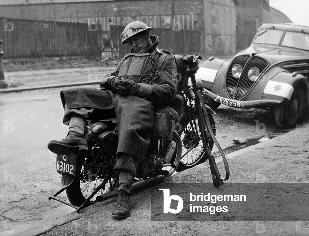 Battle of France : English motorcyclist soldier sleeping on his motorbike in Dunkerque north France 1940