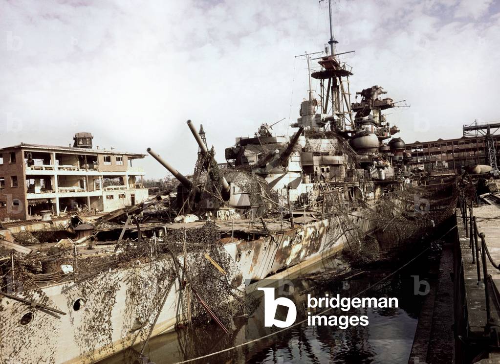 American cruiser warship in an harbour covered with fishing nets to be camouflaged, 2nd world war