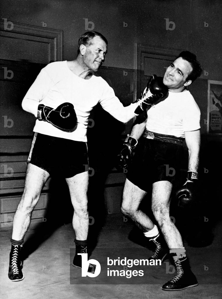 French singer Maurice Chevalier living in USA , visiting French boxer Marcel Cerdan during training for 2nd match in New York march 22, 1947