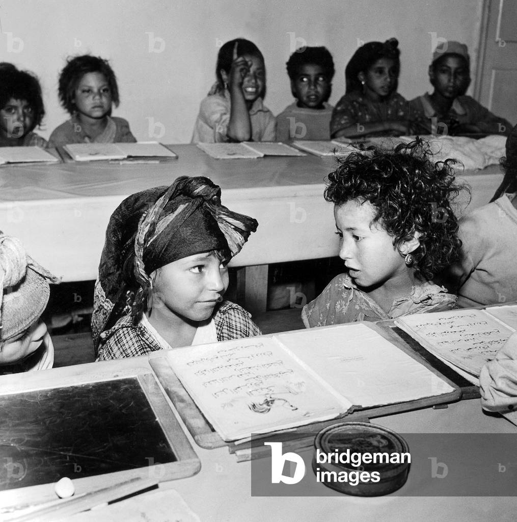 Children of Algerian soldiers who fought on the French side in the war of independence (Harkis) with their notebooks in arabic, before leaving to France, 60's