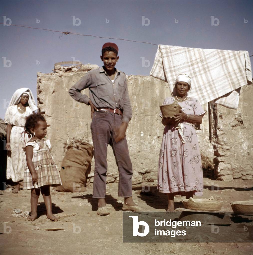 In a village in Algeria int he 60's : man, woman and girl