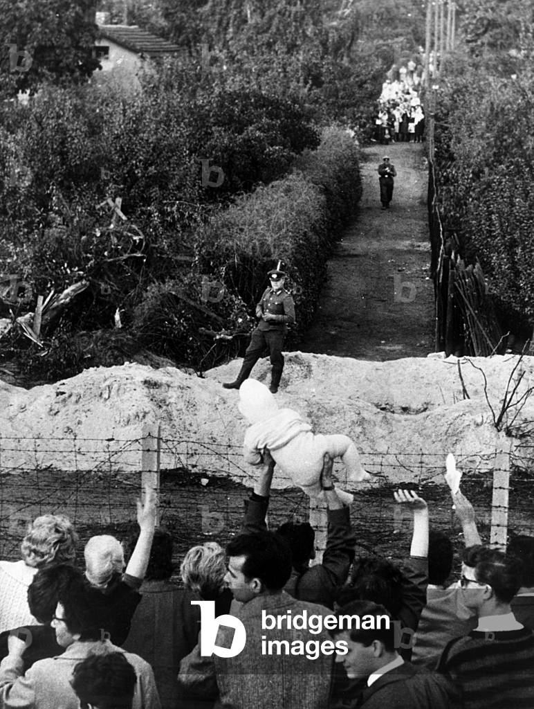 People of East Berlin waving to their parents in West Berlin, october 1st, 1961