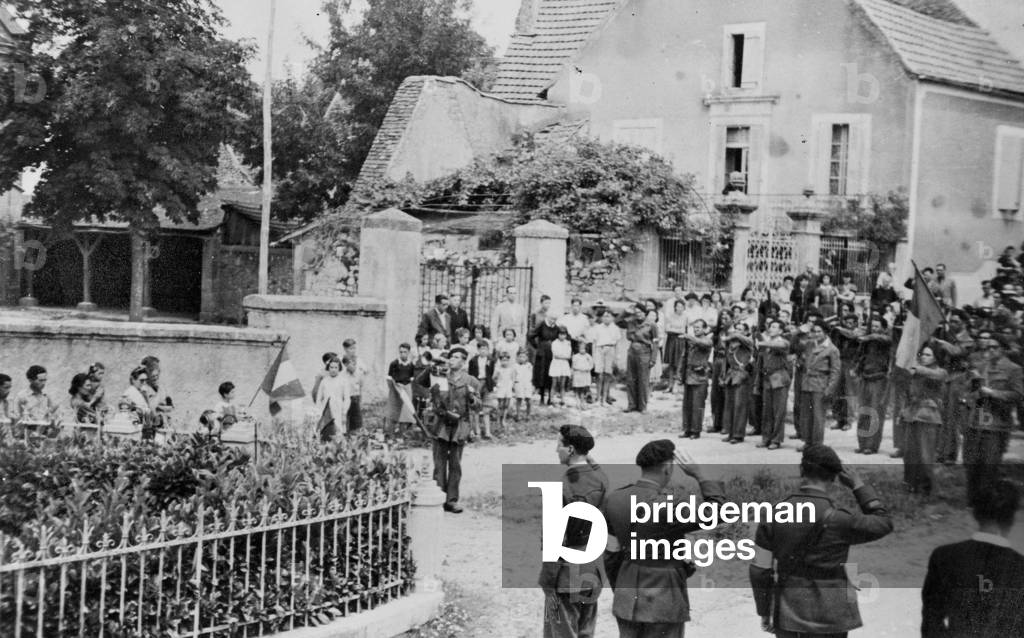 In the village of Gourdon (Lot 46) occupied by german troops, some FFI (French Forces of the Interior resistants) are celebrating the National Day the 14th July around a monument representing the Republic's Glory in 1944