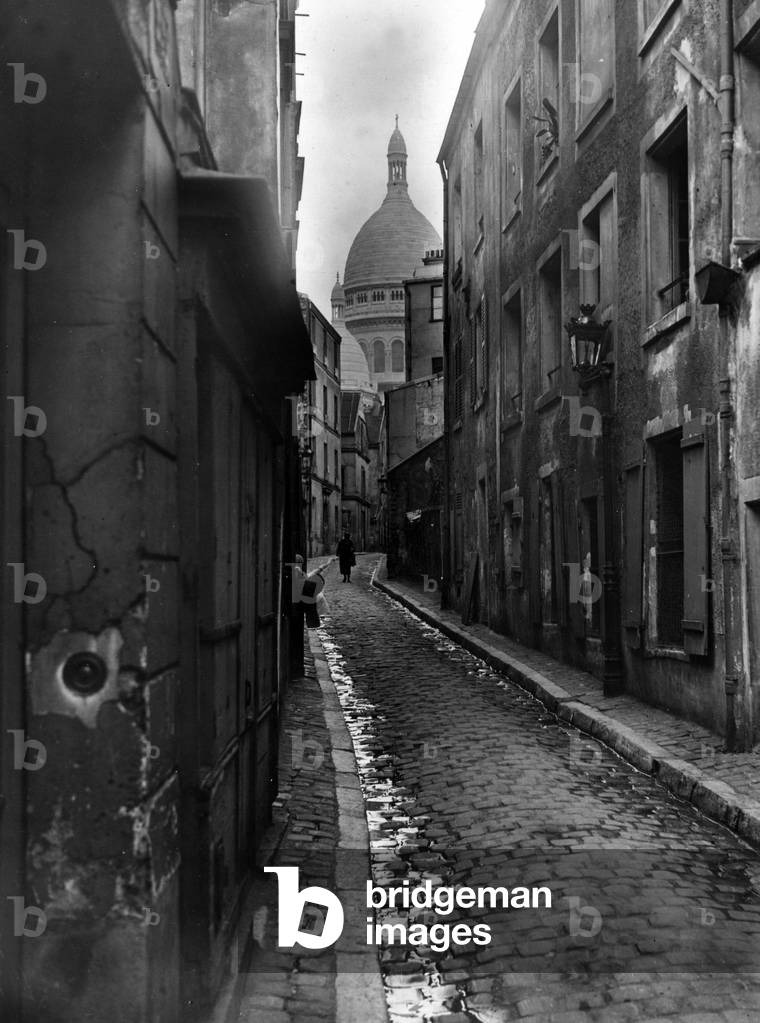 Typical street of the district of Montmartre in Paris giving on the Sacre coeur
