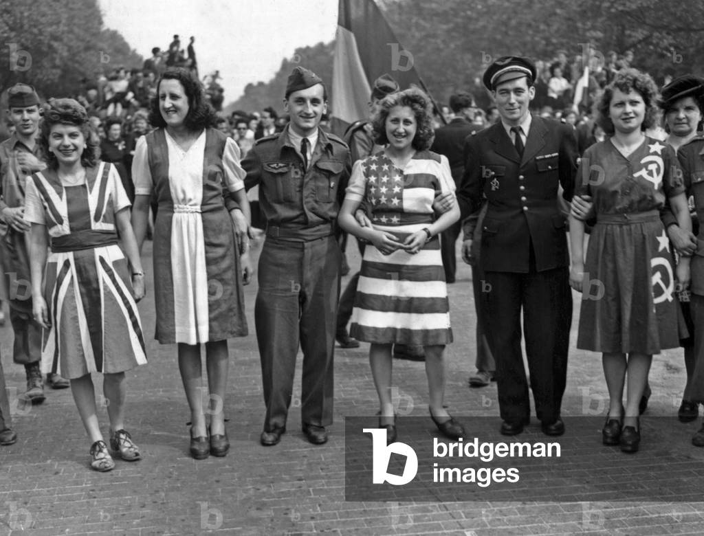 Young women in Paris clothe themselves in dresses representing the flags of the four victorious allies (Great Britain, France USA and USSR) as the French capital celebrates the official annoucement of victory in Europe, may 8, 1945