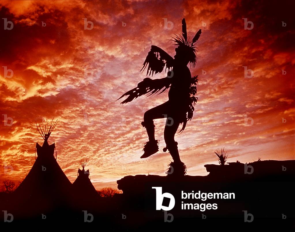 Plains Indian during ritual dance at twilight