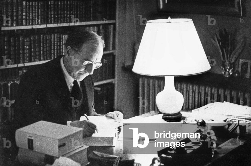 American writer Julien Green (1900-1998) working at his desk in 1968
