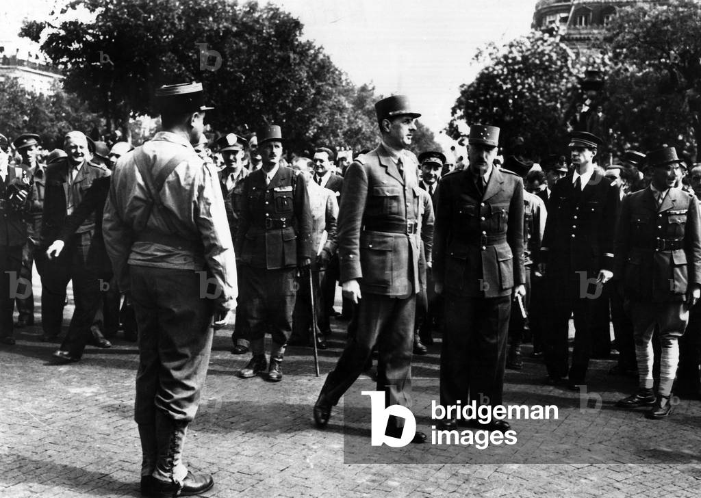 Liberation of Paris, august 26, 1944 : After paying homage to the Unknown Soldier at the Arc de Triomphe, general Charles de Gaulle reViewing troops