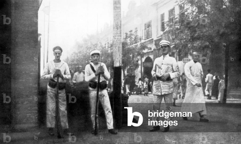 A French leading seaman and some sailors guard the street of station in a town in China about 1920