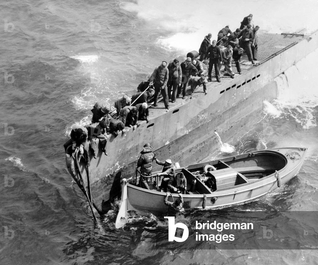 american sailormen of the USS Guadalcanal carrier preparing the towing of german submarine U505 after its capture in the Atlantic, and escort it to a military base in the Bermuda June 4, 1944, 150 miles West of Cape Blanco in French West Africa, at the time of the Battle of the Atlantic
