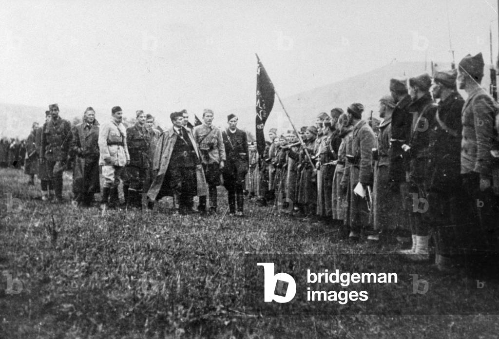 marshal Tito handing flag to the 1st proletarian brigade in Yugoslavia during ww2